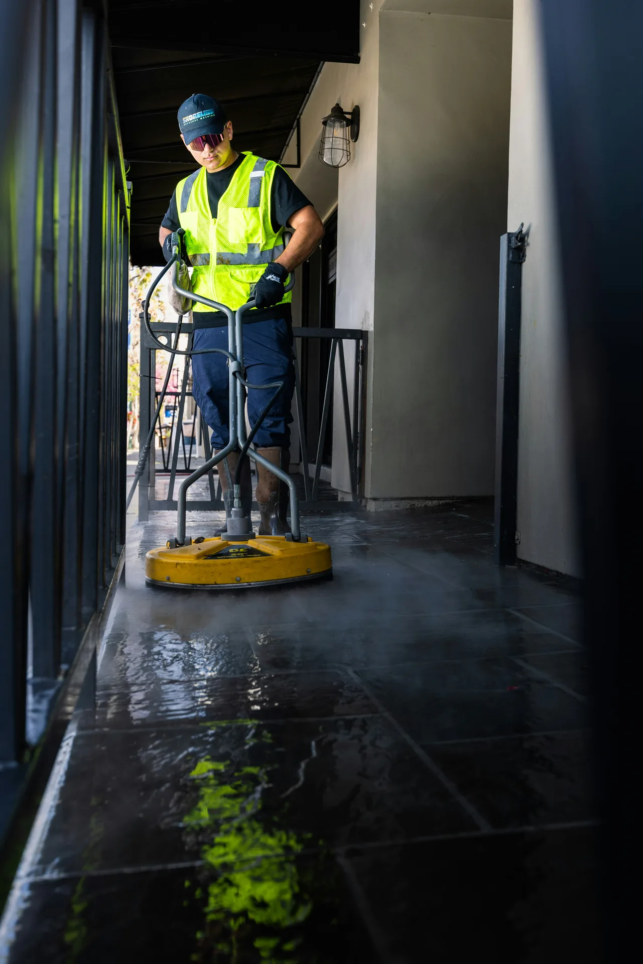 Technician Using Surface Cleaner on /oil-stain-removal/ — Birmingham Power Washing Birmingham